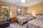 Guest bedroom with two full size beds an a TV